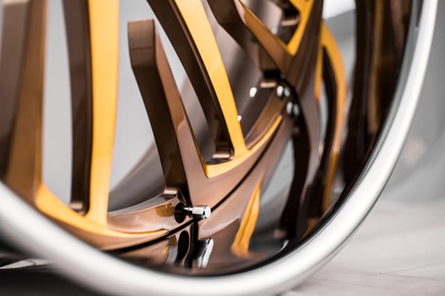 Brushed Gold Bronze Accents finish on a Savini forged wheel